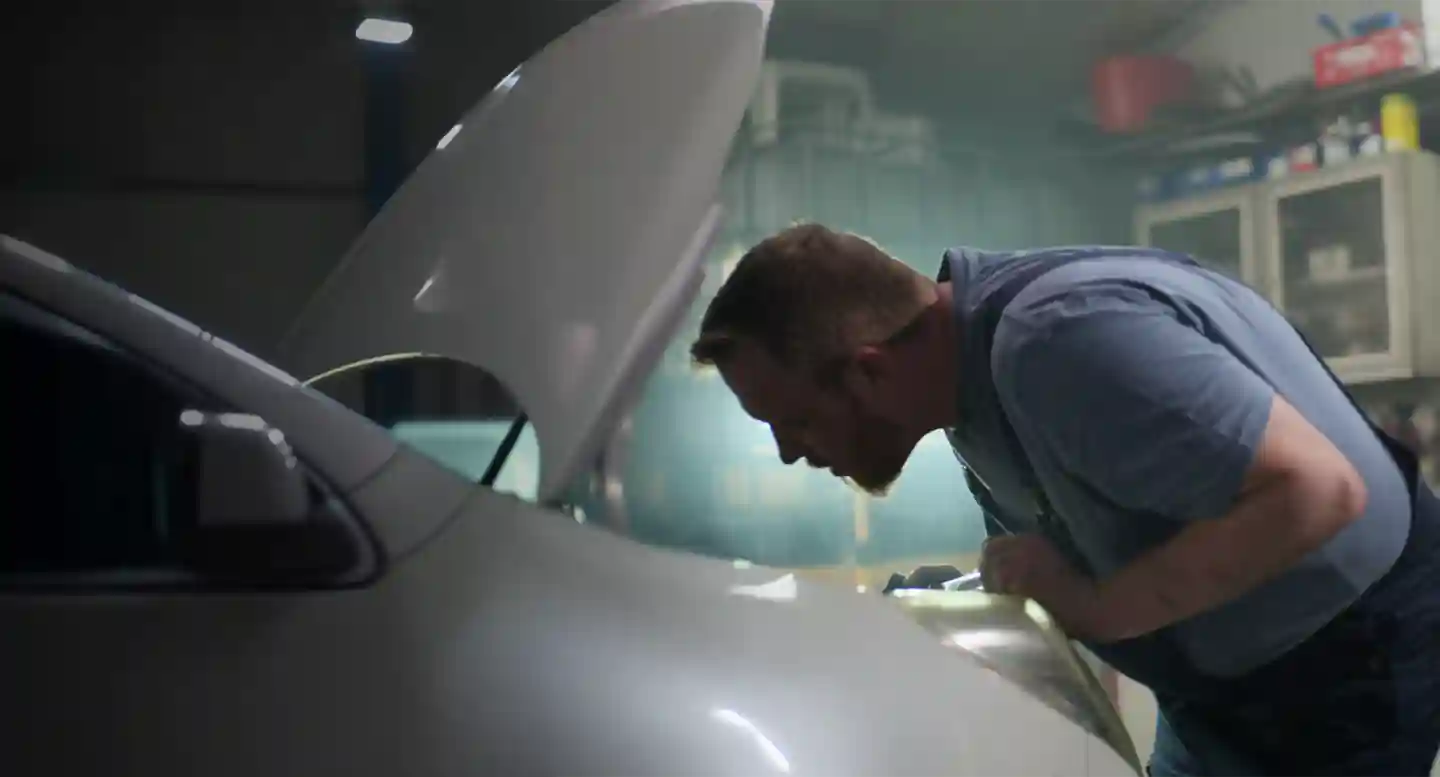 Mechanic looking in car Mechanic looking in car